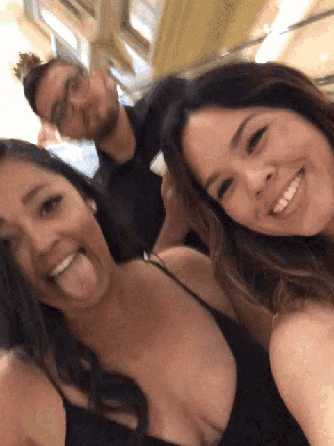 a man and two women are posing for a picture