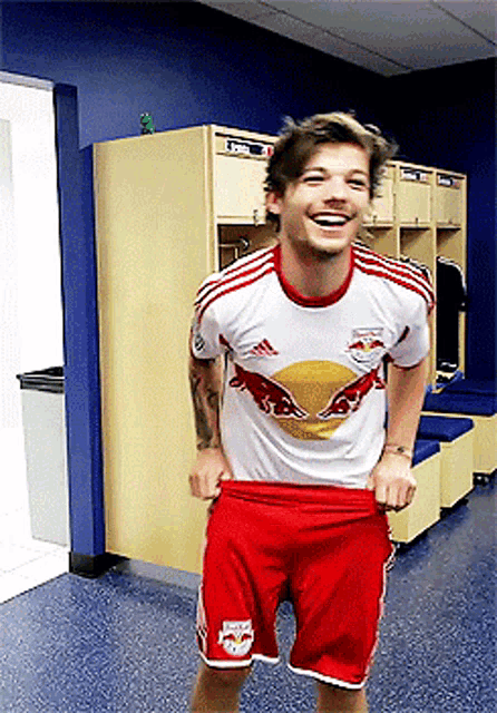 a man wearing a red bulls jersey and red shorts