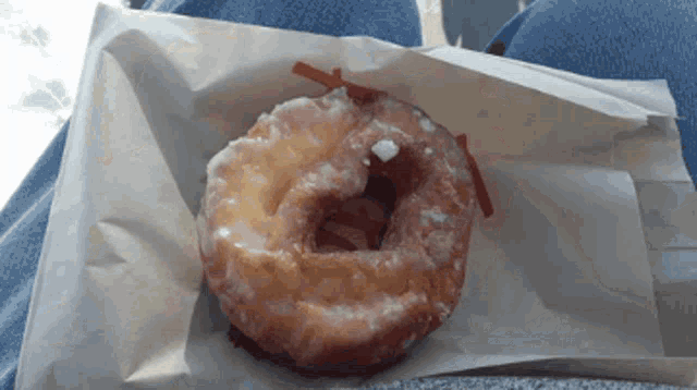 a glazed donut is sitting on a piece of paper
