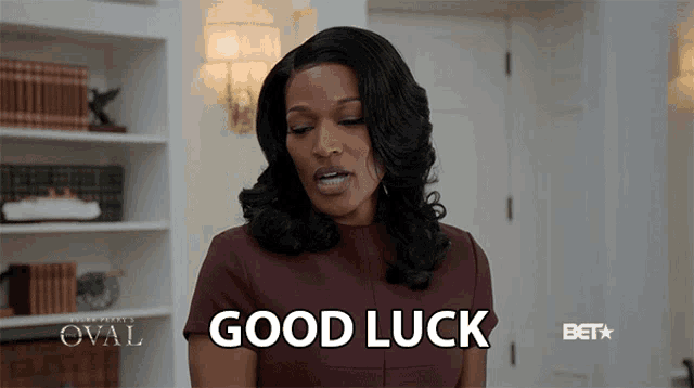 a woman says good luck in front of a sign that says oval