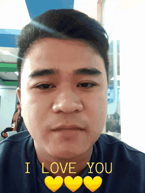 a man says i love you with three yellow hearts on his shirt