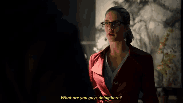 a woman in a red coat is holding a clipboard and says what are you guys doing here
