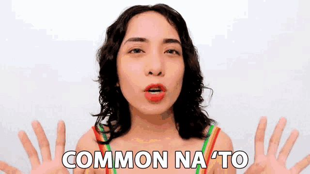 a woman in a rainbow top is making a funny face and the words common na to are above her