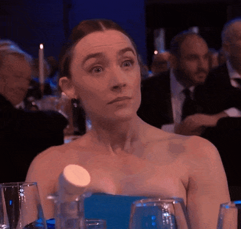 a woman in a blue dress is sitting at a table