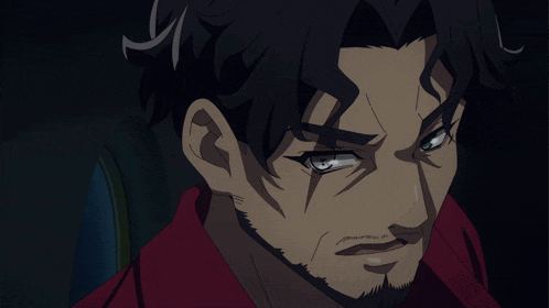 a close up of a man 's face with a red shirt