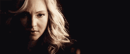 a close up of a woman 's face in the dark .