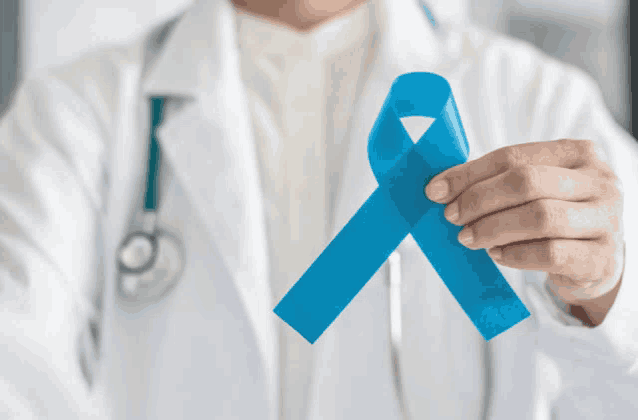 a doctor is holding a blue ribbon in his right hand