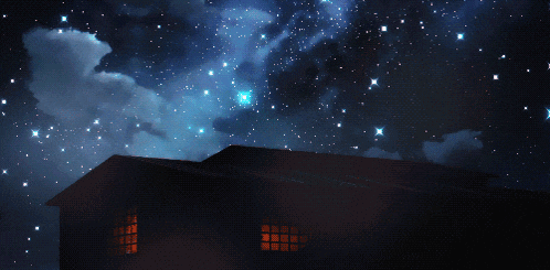 a house is lit up at night with a starry sky behind it
