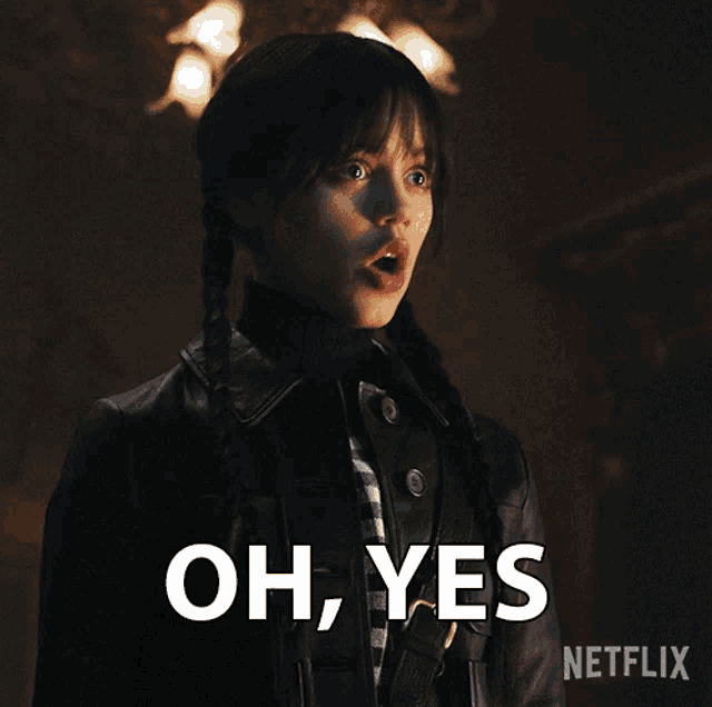 a girl with pigtails and a black jacket says " oh yes "