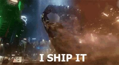 a giant monster is flying through the air with the words `` i ship it '' written on the bottom .