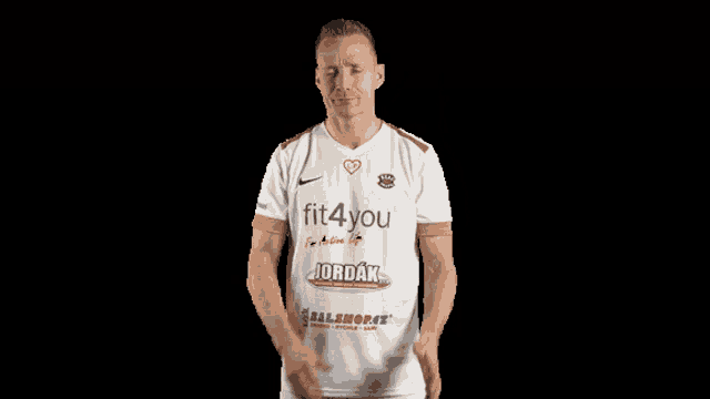 a man wearing a white shirt with fit4you and jordak written on it