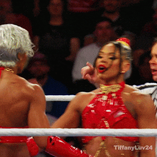 a woman in a red top is standing in a boxing ring with tiffany luv24 written on the bottom