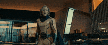 a man in a yellow and blue superhero suit is standing in a room
