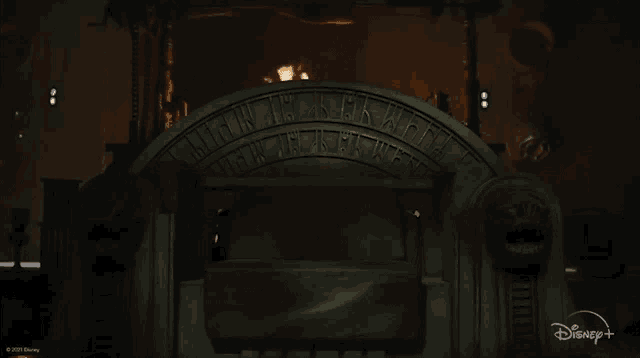 a dark room with a disney logo on the bottom left