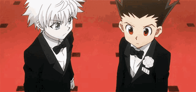 two anime characters are standing next to each other on a red carpet ..