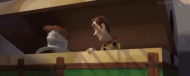 woody and a stuffed shark from toy story laughing