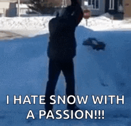 a man is standing in the snow with a shovel and says `` i hate snow with a passion ! ''