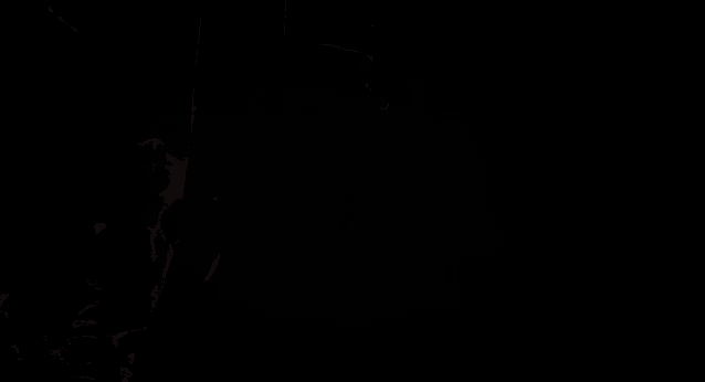 a man and woman kissing in a dark room