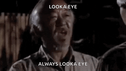 a man is talking to another man in a dark room and says `` look a eye , always look a eye '' .