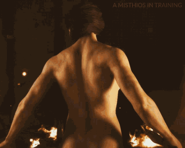 a naked man is standing in front of a fire with the words a masthios in training above him