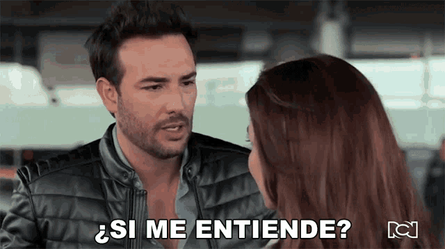 a man and a woman are looking at each other and the man is saying si me entiende