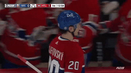 a hockey player with the name slafkovsky on his back