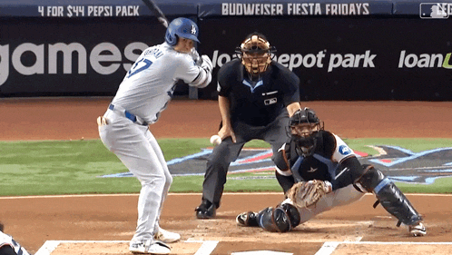 a baseball game is being played in front of a budweiser fiesta fridays banner