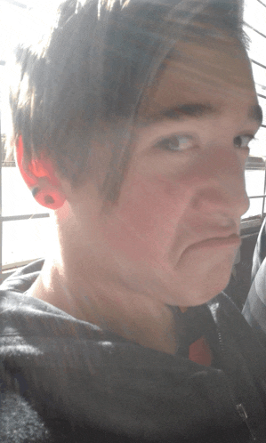 a close up of a person 's face with a serious look on their face