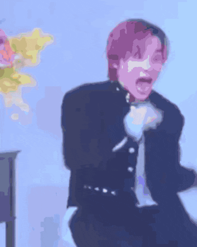 a blurry picture of a person with purple hair screaming