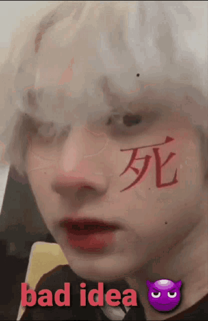 a close up of a person with chinese writing on their face