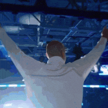 a man with his arms outstretched in a blue room