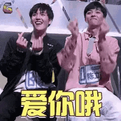 two young men are giving the middle finger in a chinese language .