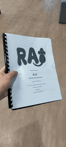 a person is holding a book titled rat