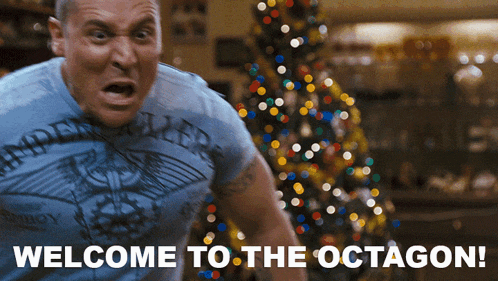 a man wearing a shirt that says ' welcome to the octagon ' on it