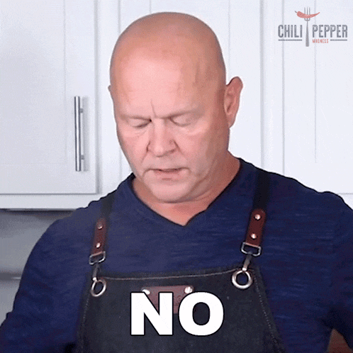 a man wearing an apron says no with his eyes closed .