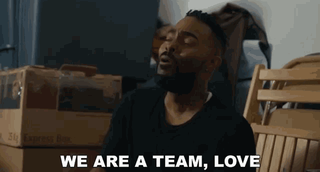 a man with a beard says we are a team love while sitting in a chair