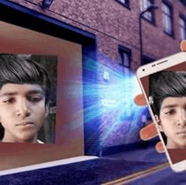 a man is holding a cell phone with a picture of his face on it .
