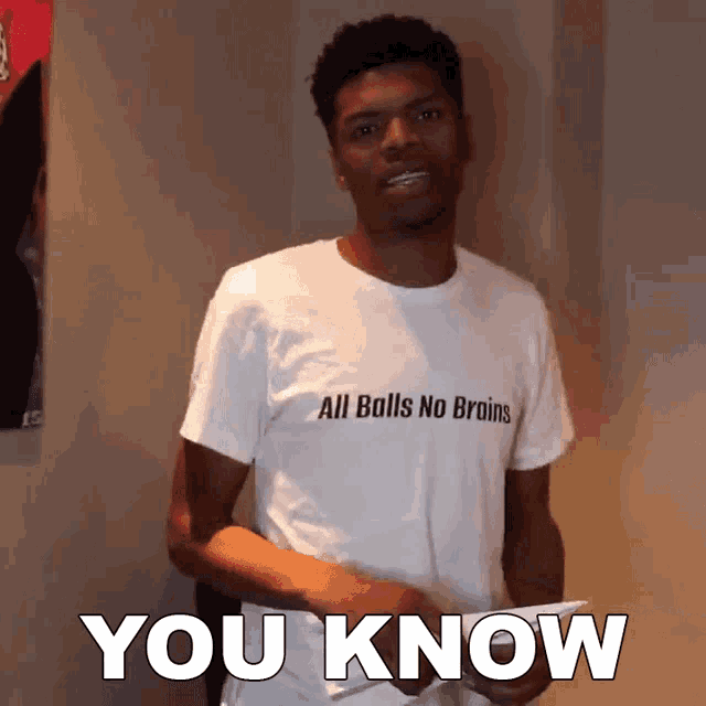 a young man wearing a shirt that says all balls no brains