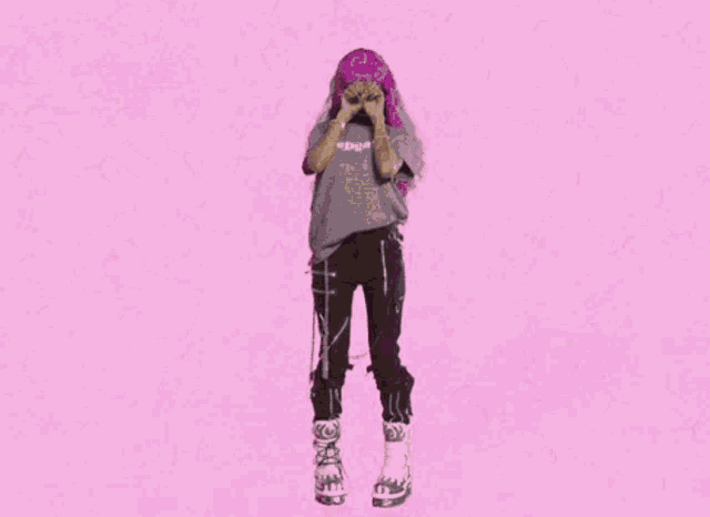 a woman with pink hair and a pepsi shirt covering her eyes