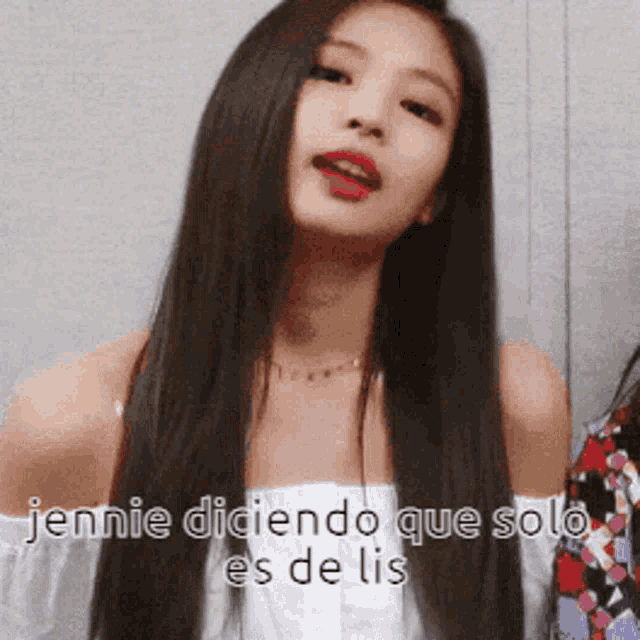 a woman with long hair is wearing a white off the shoulder top with the words jennie diciendo que solo es de lis below her
