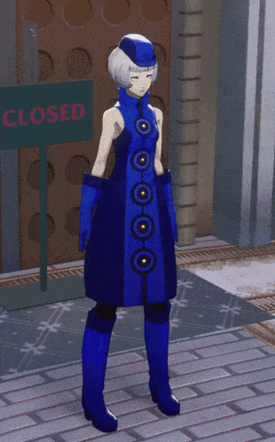 a woman in a blue dress is standing in front of a closed sign