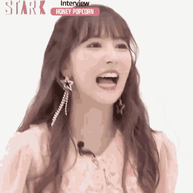 a girl with her mouth open is wearing a pink shirt