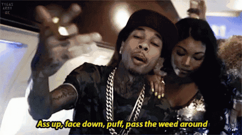 a man in a hat says " ass up face down puff pass the weed around " in front of a woman