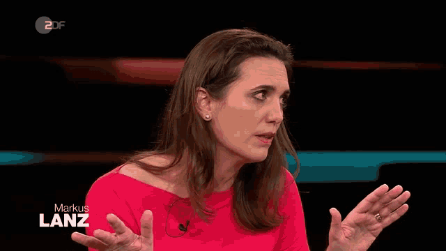 a woman in a red dress is talking on a tv show called markus lanz