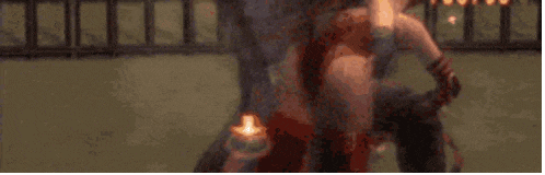 a blurry picture of a person standing in front of a fire with smoke coming out of it .
