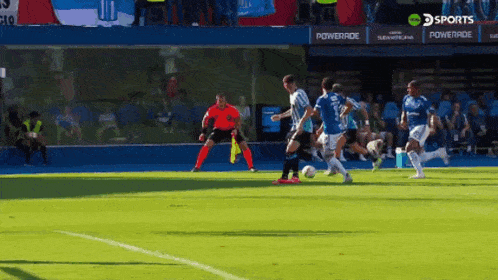 a group of soccer players on a field with a powerade ad behind them
