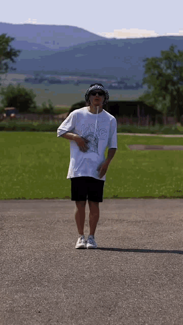 a man wearing a white shirt that says mc
