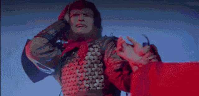 a pixelated image of a man in armor holding a red flag .