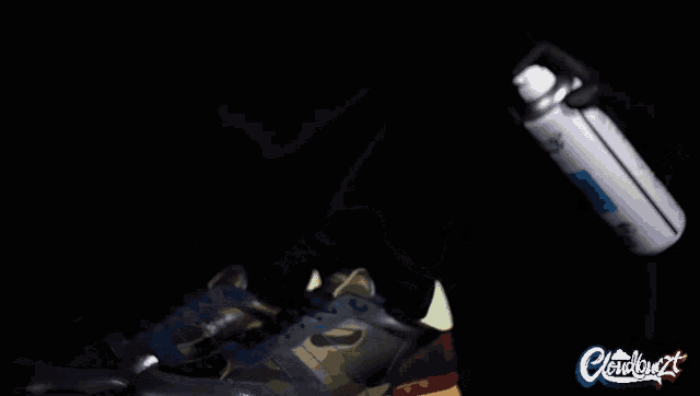 a pair of shoes being sprayed with a spray can that says cloudburst