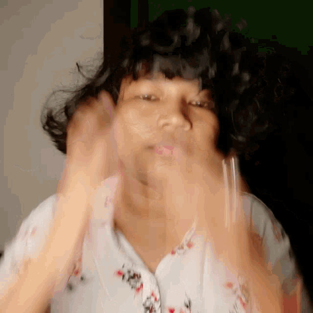 a blurry picture of a woman 's face with her hair blowing in the wind